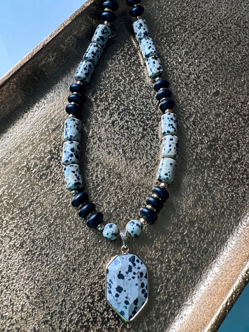 Hue La La Gems statement necklace featuring dalmatian jasper beads, matte black beads, and a geometric jasper pendant.