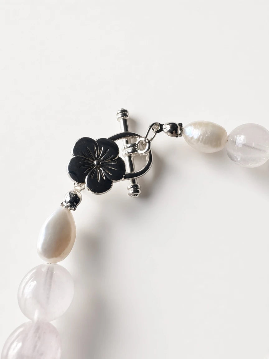 Hue La La Gems handcrafted necklace featuring rose quartz beads, a baroque pearl, and a silver floral toggle clasp.