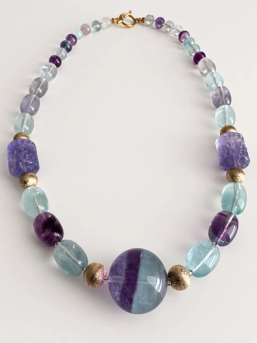 Hue La La Gems fluorite beaded necklace with purple and green stones, carved beads, and gold-tone toggle clasp.