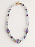 Hue La La Gems fluorite beaded statement necklace with purple and green stones, gold-tone spacers, and toggle clasp.