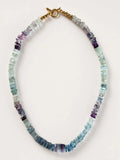 Hue La La Gems multi-colored fluorite disc bead necklace with a gold-tone toggle clasp on a white background.