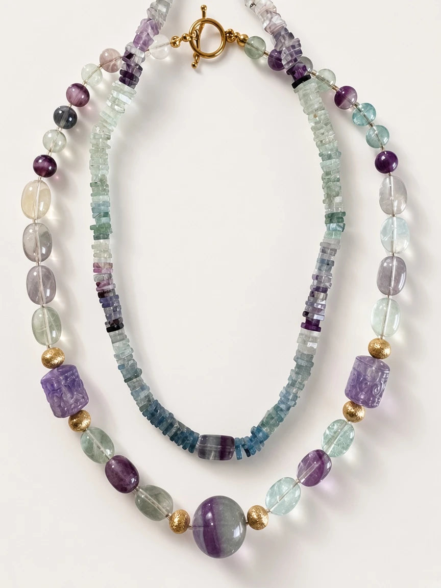 Hue La La Gems fluorite beaded statement necklace with purple and green stones, gold-tone spacers, and toggle clasp.