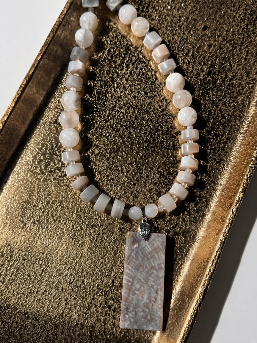 Hue La La Gems handcrafted statement necklace with a rectangular fossilized coral pendant and moonstone-style beads.