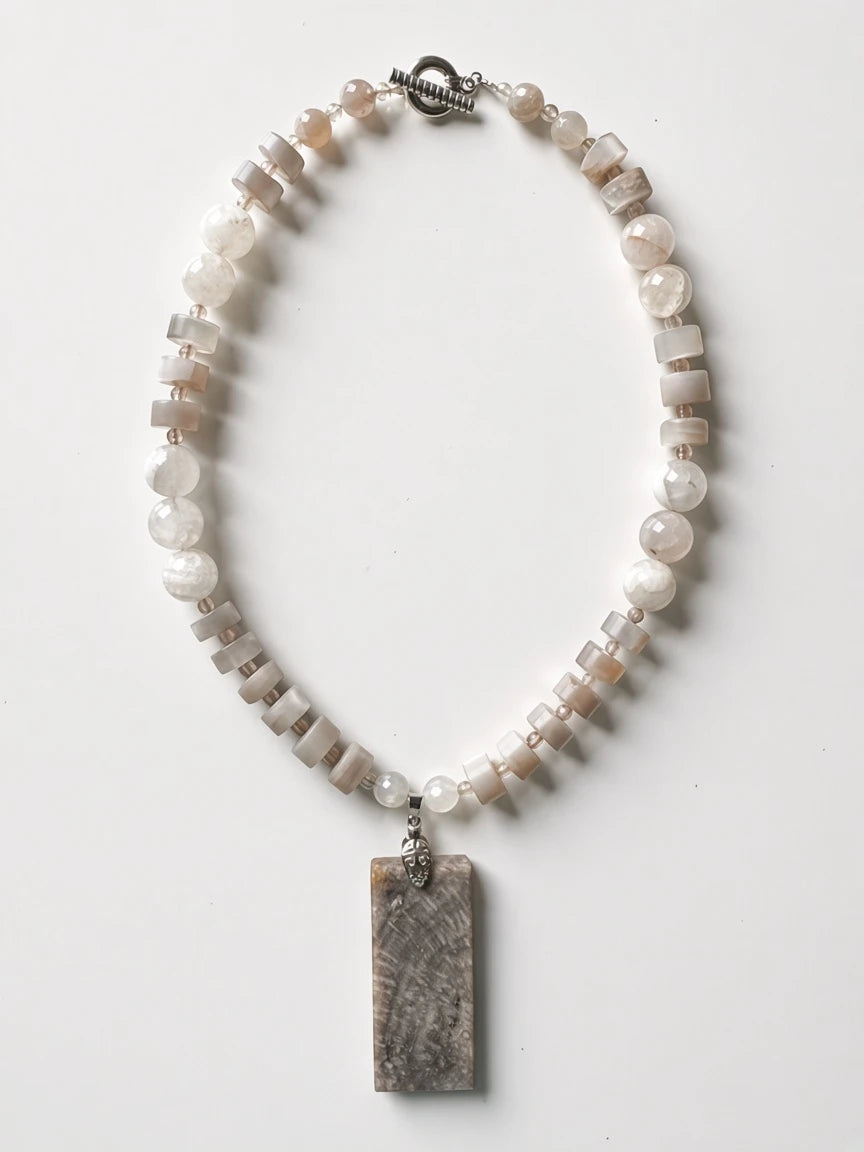 Hue La La Gems handcrafted statement necklace featuring a rectangular fossilized coral pendant and moonstone-style beads.