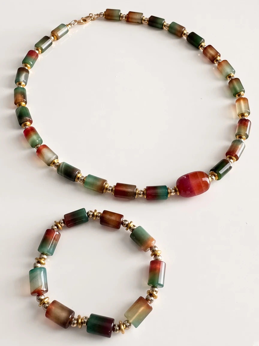 Hue La La Gems multi-colored gemstone bead necklace and matching bracelet with gold-tone spacers on white background