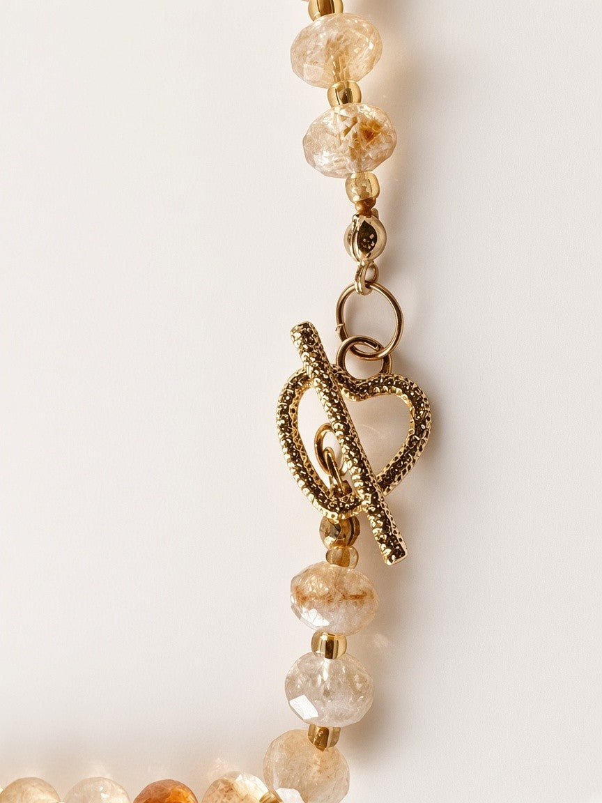 Hue La La Gems handcrafted honey-toned gemstone necklace featuring a textured gold heart-shaped toggle clasp