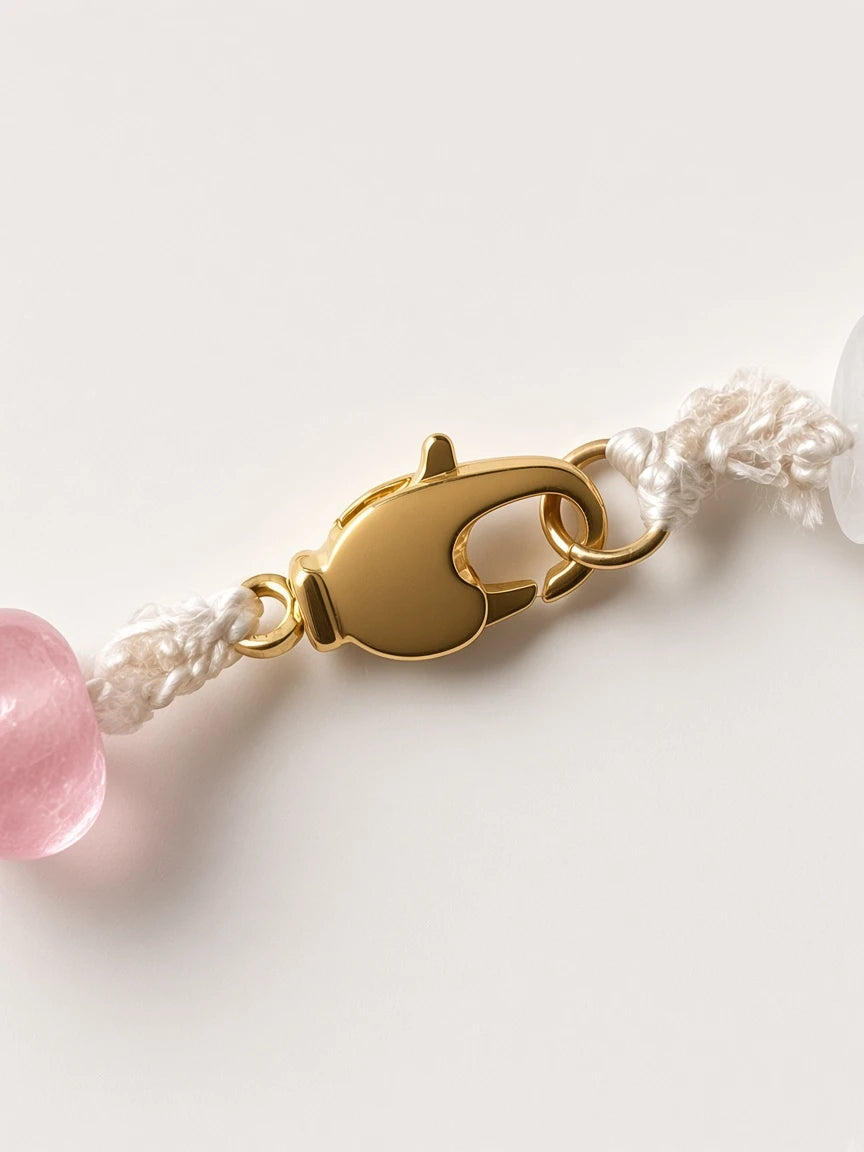 Hue La La Gems beaded necklace featuring a polished gold-tone lobster clasp on a durable white cord with pink beads.