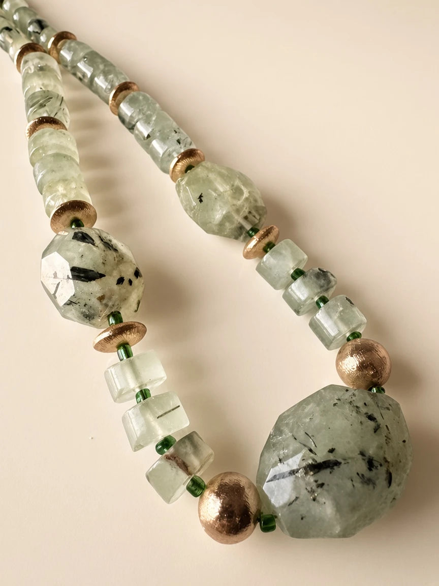 Hue La La Gems beaded statement necklace featuring pale green translucent gemstones and polished gold-tone accents.