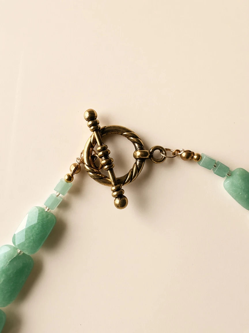 Hue La La Gems green jade statement necklace featuring faceted rectangular beads and a vintage gold-tone toggle clasp.