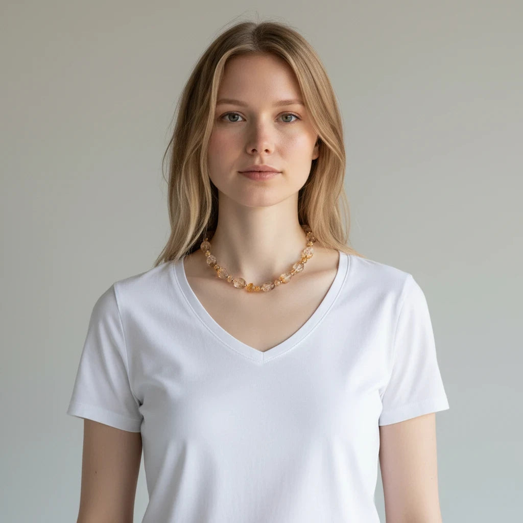 A model wearing a Hue La La Gems handcrafted honey-toned gemstone necklace with tumbled beads and a gold toggle clasp.