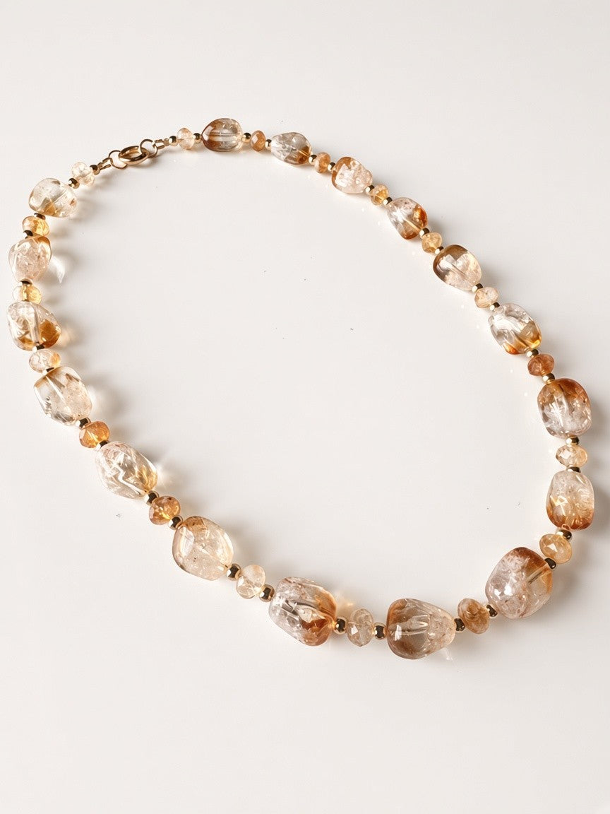 Hue La La Gems handcrafted statement necklace featuring honey-toned tumbled gemstone beads and a gold toggle clasp.