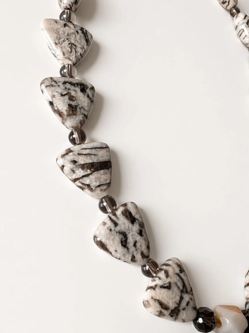 Hue La La Gems artisan statement necklace featuring triangular patterned jasper stones and smoky translucent beads.