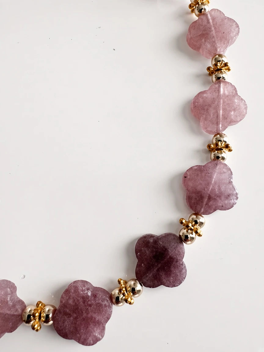 Hue La La Gems beaded floral statement necklace featuring mauve gemstone flowers and polished gold-tone metal beads.