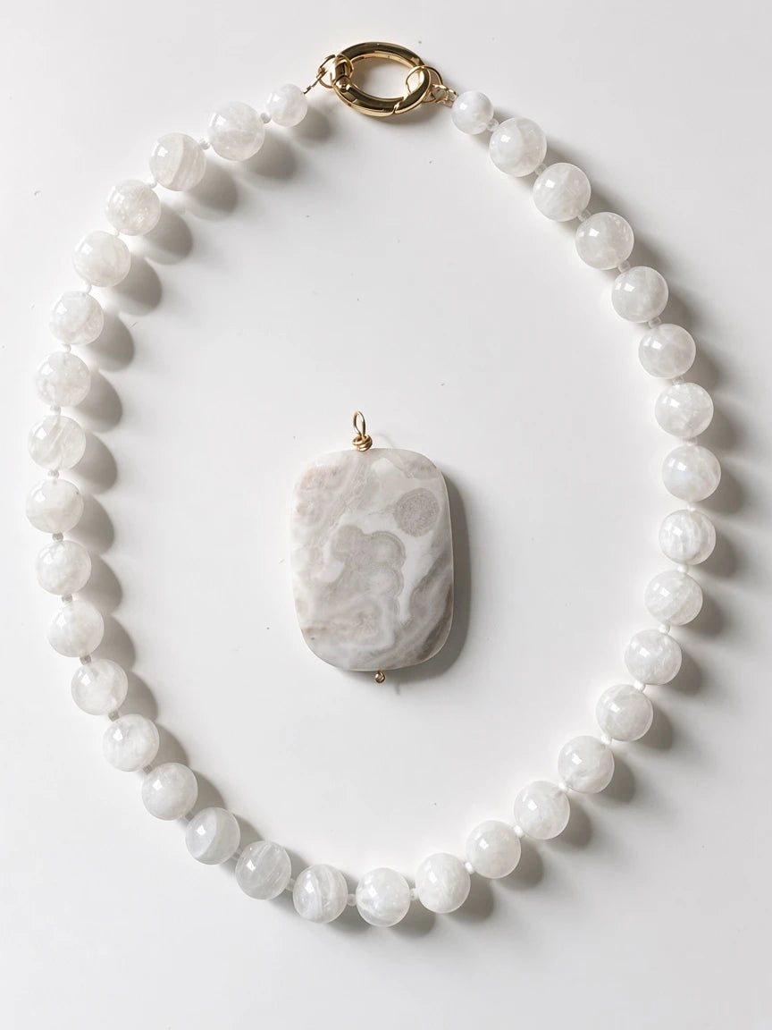 Hue La La Gems beaded statement necklace featuring iridescent moonstone beads and a large rectangular marble pendant.