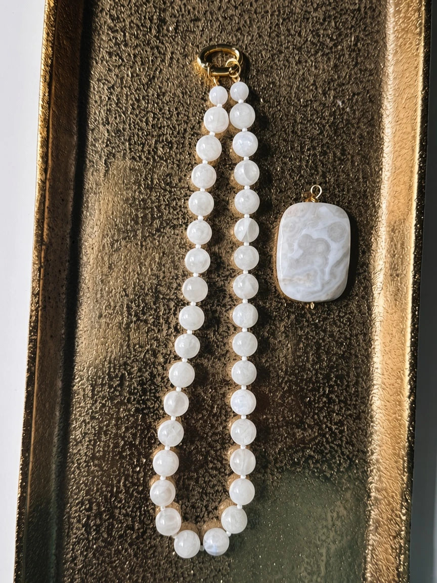 Hue La La Gems beaded moonstone necklace with a rectangular marbled pendant and gold-tone clasp on a gold tray.