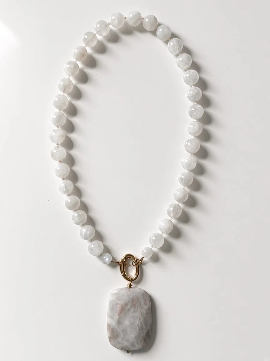 Hue La La Gems beaded statement necklace featuring iridescent moonstone beads and a large rectangular marble pendant.