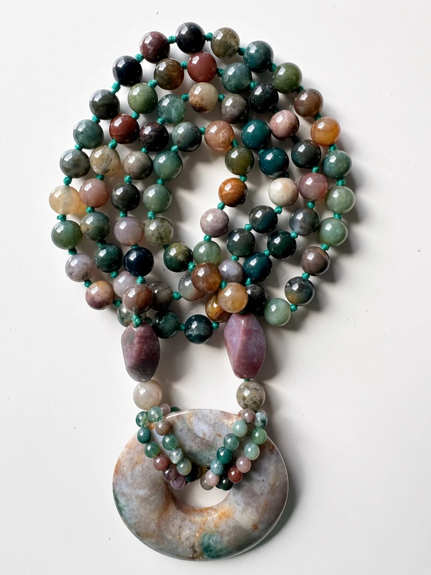 Hue La La Gems handcrafted statement necklace featuring moss agate beads and a large polished stone donut pendant.