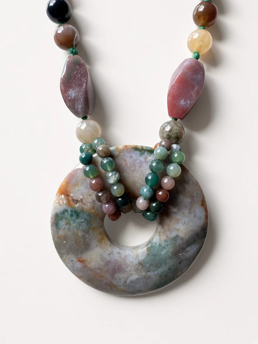 Hue La La Gems handcrafted statement necklace featuring a large moss agate donut pendant and multi-colored gemstone beads