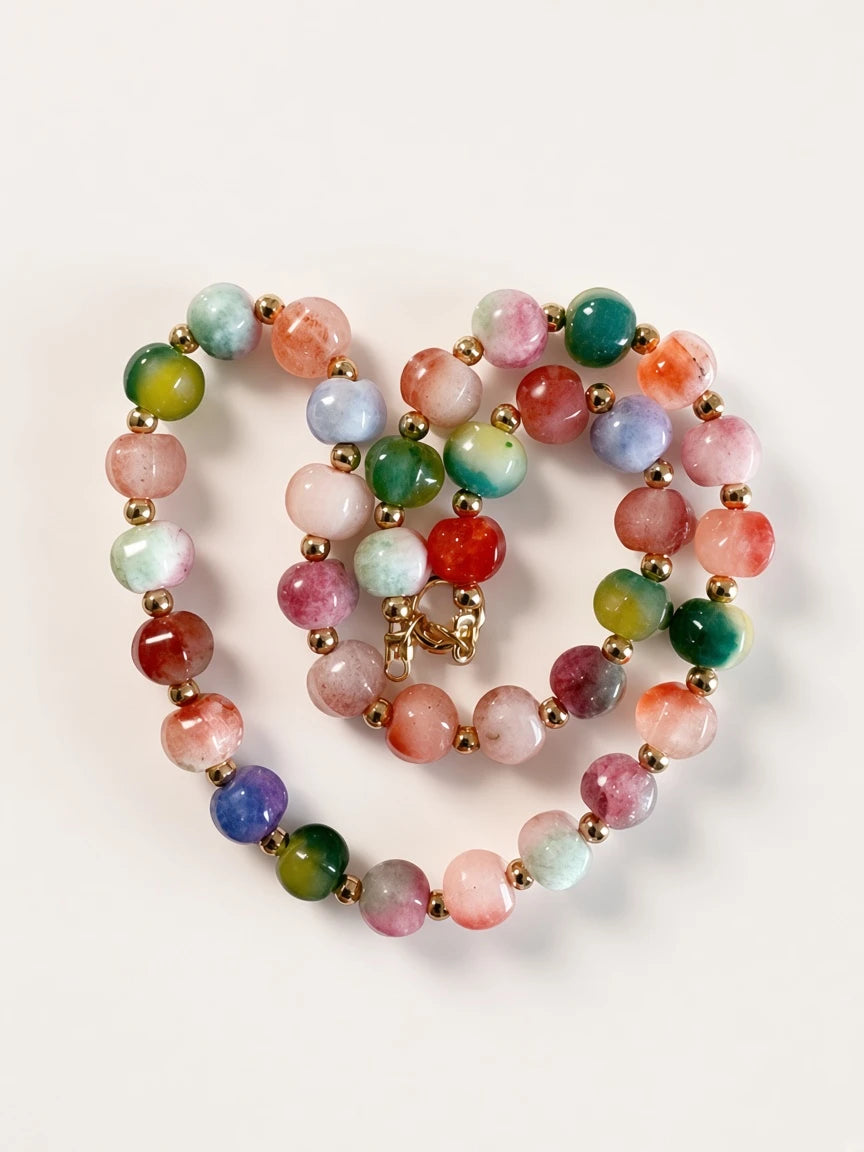 Hue La La Gems multi-colored gemstone beaded necklace with gold-tone spacers and a secure clasp on a white background.