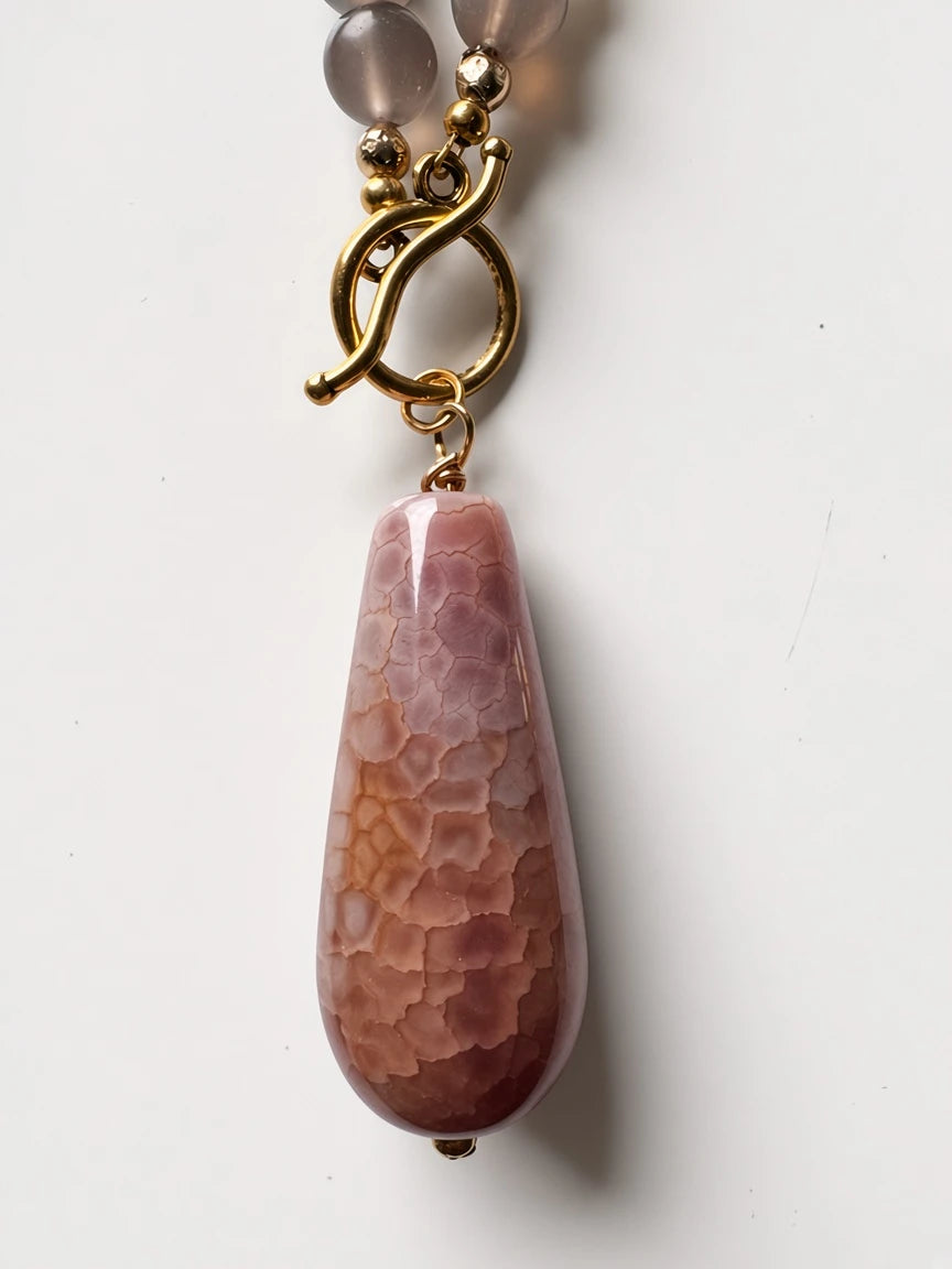 Hue La La Gems statement necklace featuring a pink crackle agate pendant and gold-tone toggle clasp.