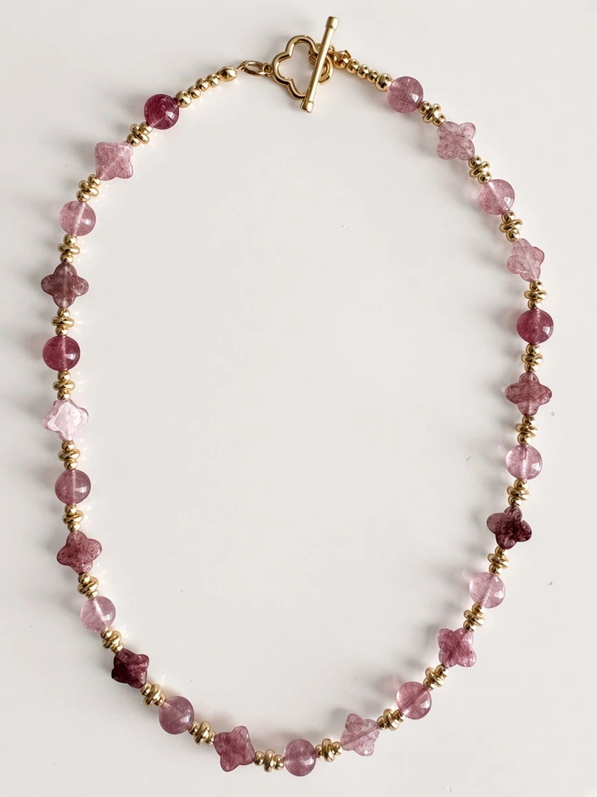 Hue La La Gems beaded statement necklace featuring pink gemstone spheres, flower carvings, and gold-tone spacer beads.