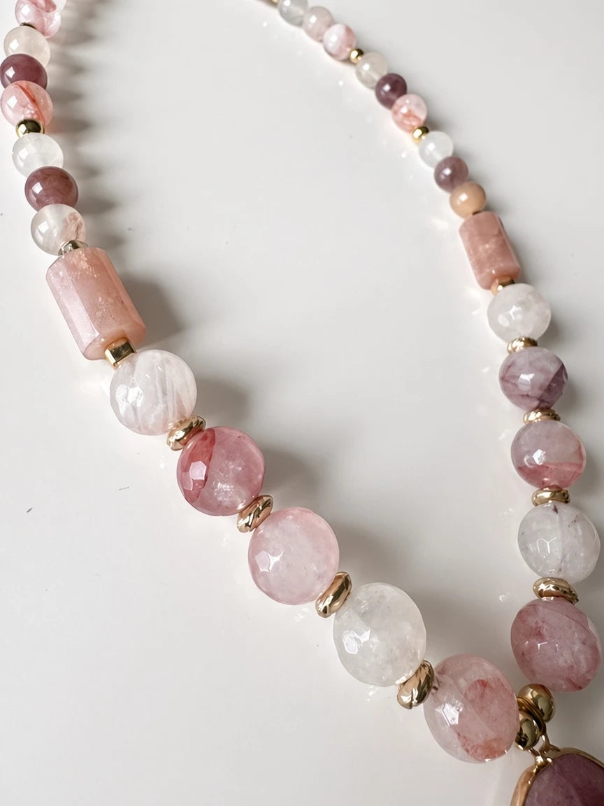 Hue La La Gems beaded statement necklace featuring faceted pink and mauve gemstone beads with gold-tone spacers.