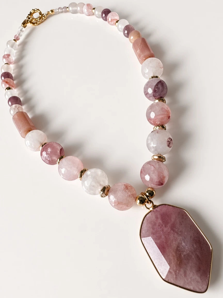 Hue La La Gems beaded statement necklace with pink gemstone beads, gold spacers, and a large geometric pendant.