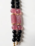 Hue La La Gems beaded necklace featuring polished black beads, pink quartz cylinders, and gold-tone spacers.
