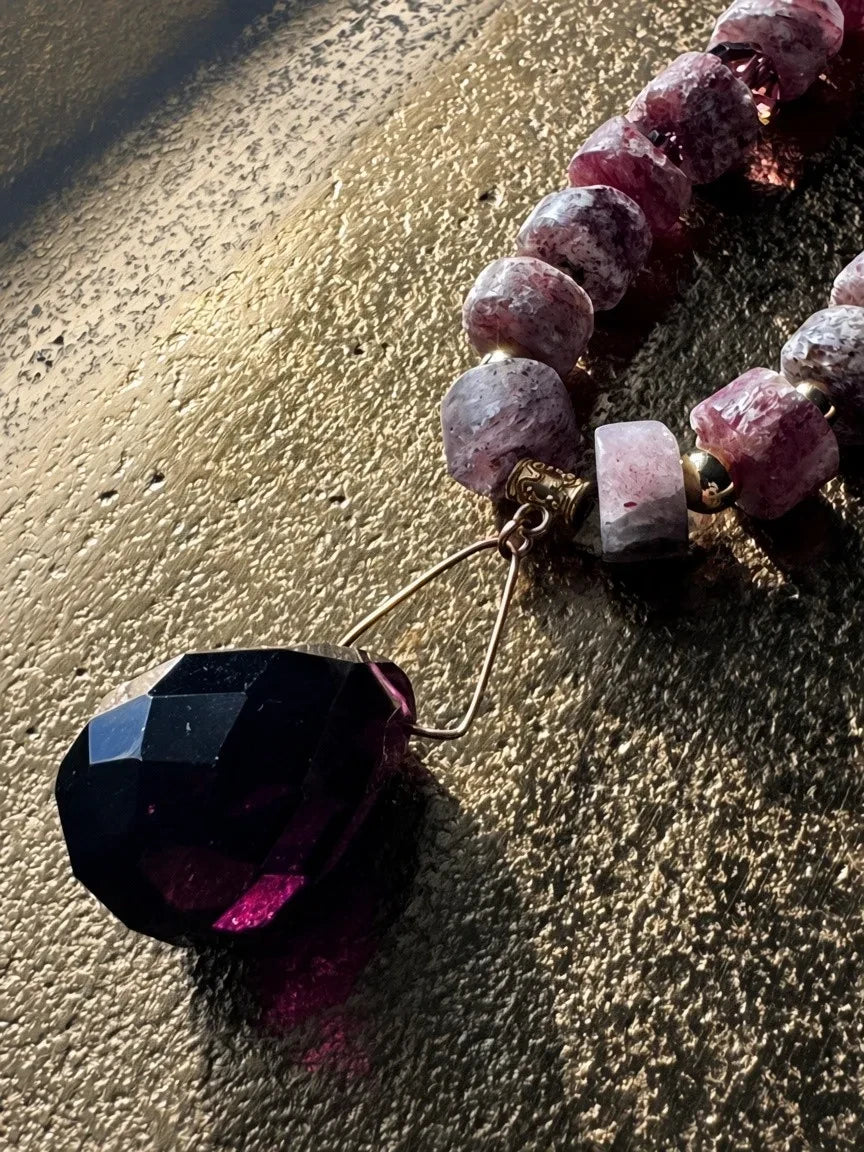 Hue La La Gems artisan statement necklace with faceted purple gemstone pendant and textured pink stone beads.