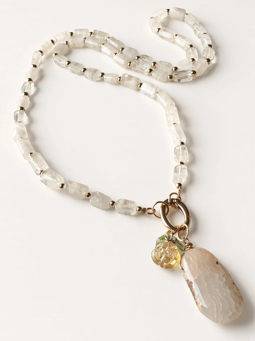 Hue La La Gems beaded statement necklace featuring rectangular clear quartz beads, gold spacers, and a stone pendant.