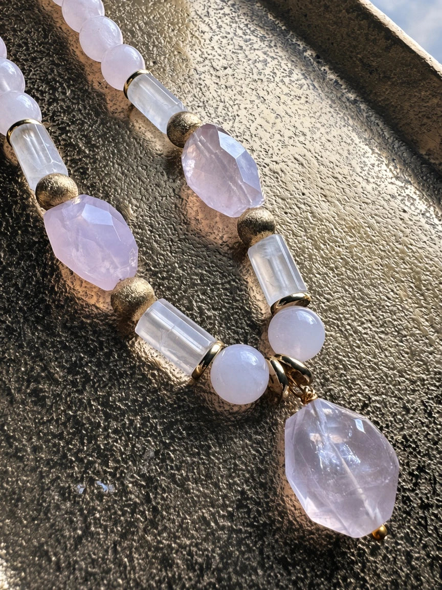 Hue La La Gems beaded necklace featuring rose quartz and clear quartz beads with gold-tone accents on a gold tray.