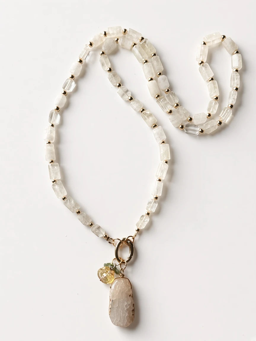 Hue La La Gems beaded statement necklace featuring clear quartz, gold-tone spacers, and an organic stone pendant.