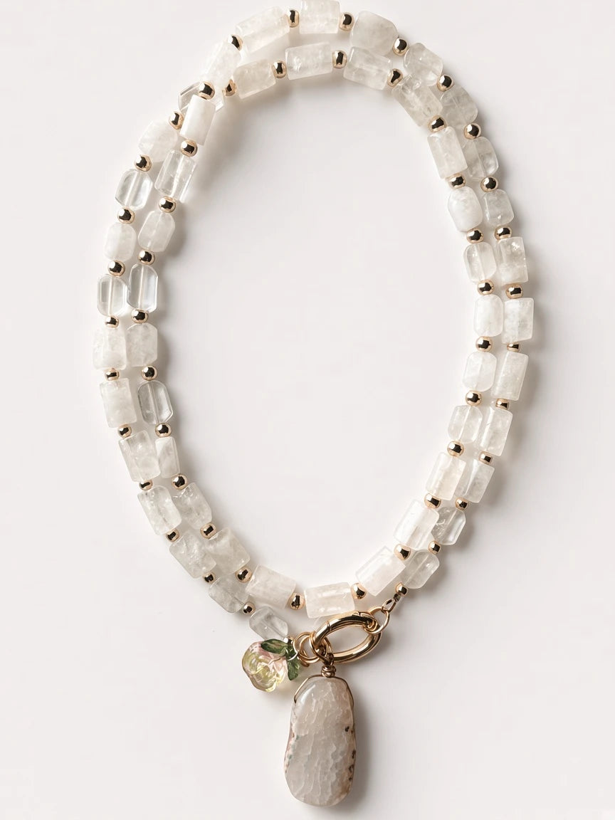 Hue La La Gems beaded statement necklace with clear quartz, gold-tone spacers, stone pendant, and floral charm.