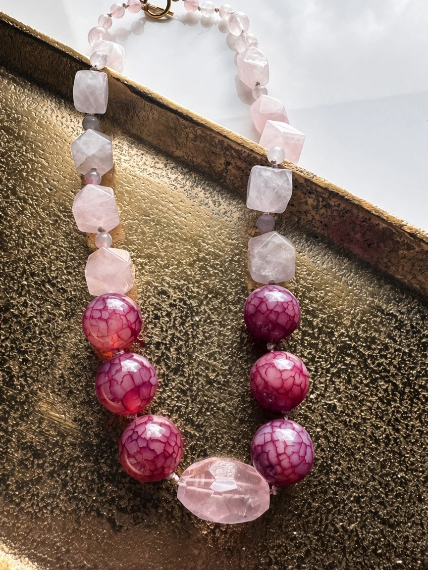 Hue La La Gems statement necklace featuring faceted rose quartz and crackled berry agate beads with a gold toggle clasp.