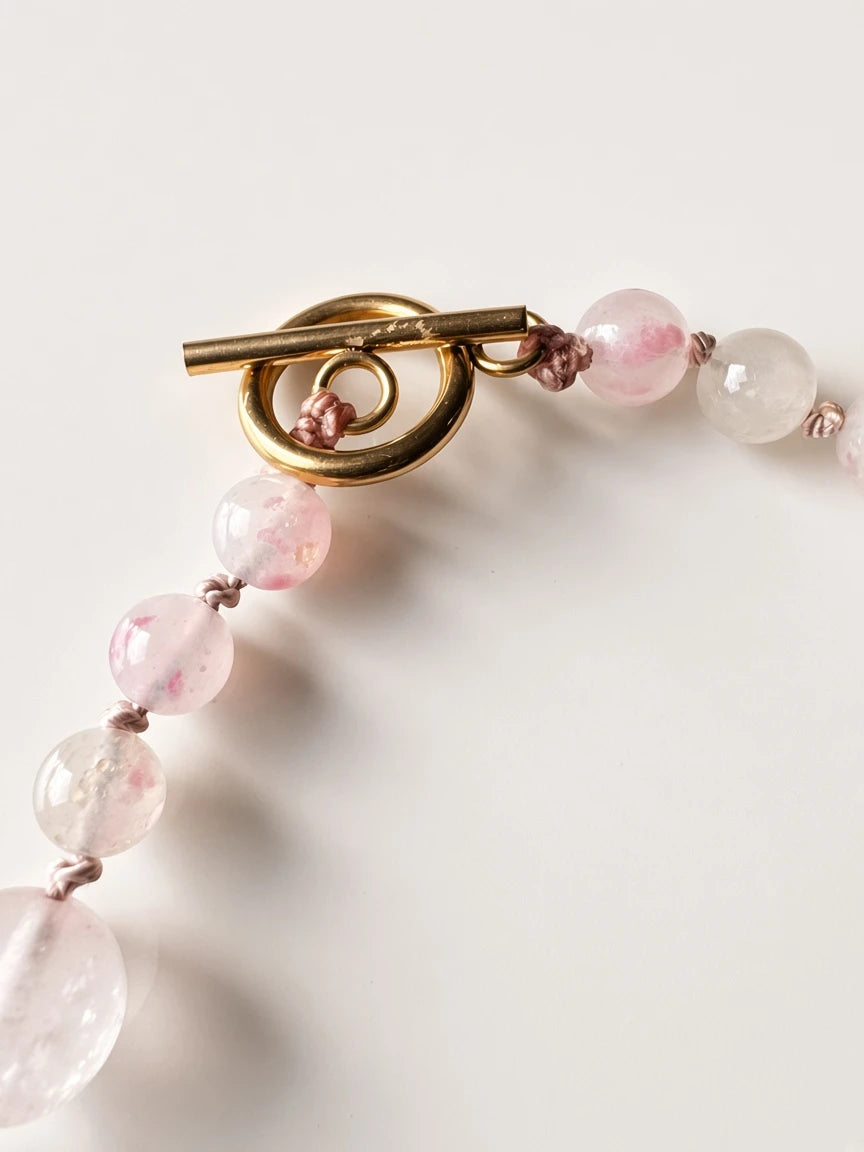 Hue La La Gems handcrafted statement necklace featuring rose quartz beads and a polished gold-tone toggle clasp.