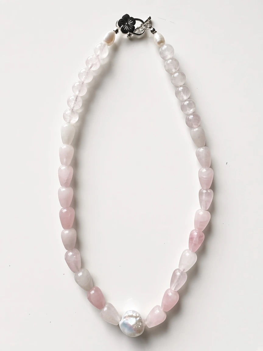 Hue La La Gems handcrafted rose quartz teardrop bead necklace with a baroque pearl center and floral silver clasp.