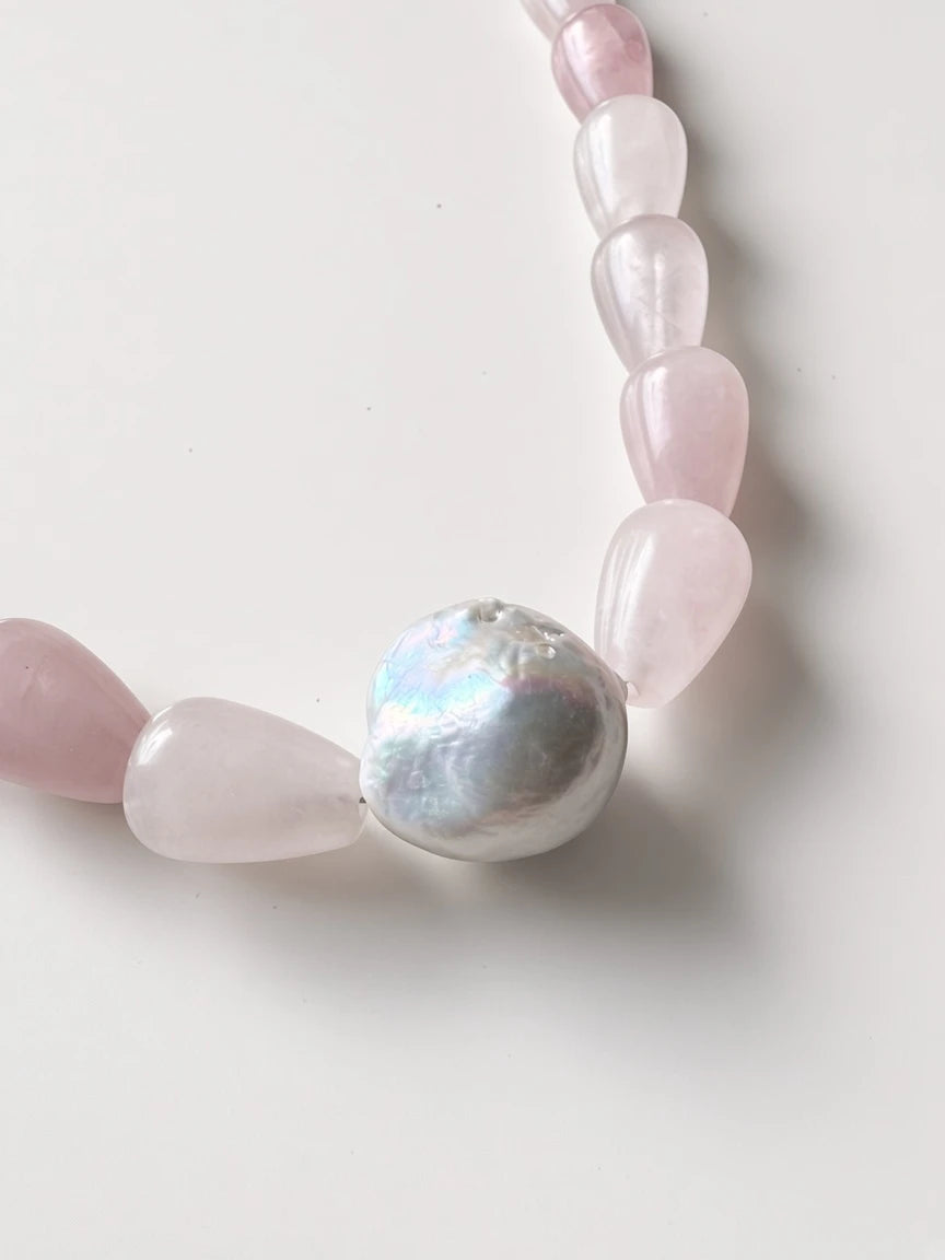 Hue La La Gems handcrafted necklace featuring teardrop rose quartz beads and a central lustrous baroque pearl.