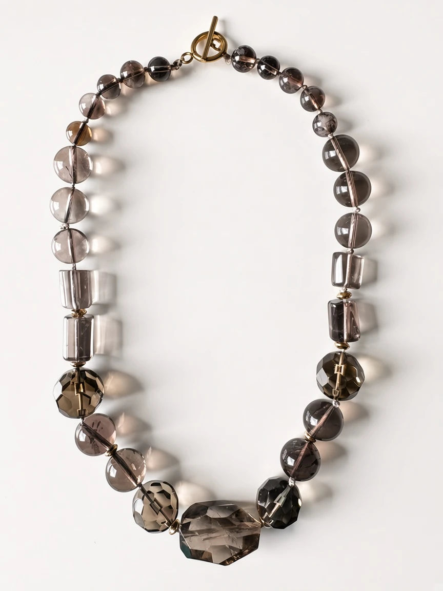 Hue La La Gems statement necklace featuring smoky quartz beads in taupe and charcoal with a gold-tone toggle clasp.
