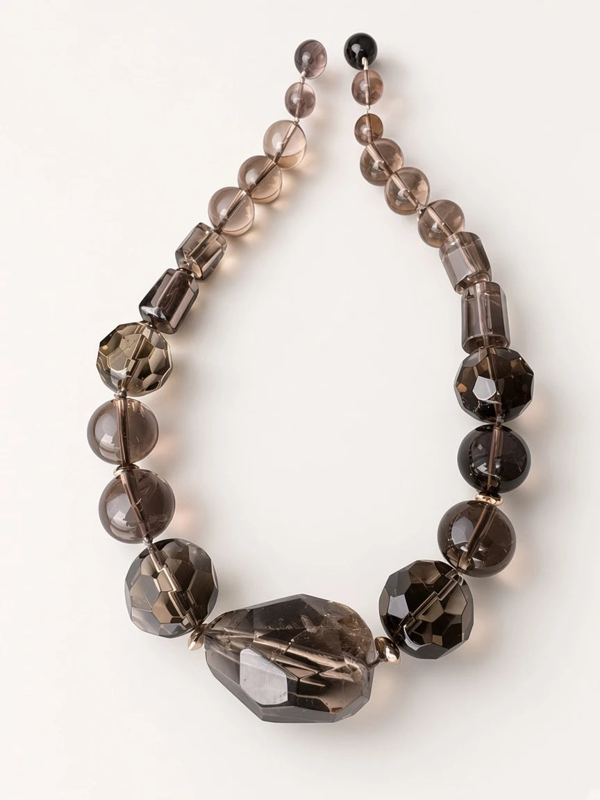 Hue La La Gems smoky quartz beaded statement necklace with faceted rounds, cylinders, and a large asymmetrical pendant.