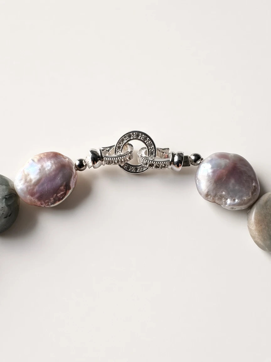 Hue La La Gems handcrafted necklace featuring iridescent stone beads and a decorative silver-tone toggle clasp.