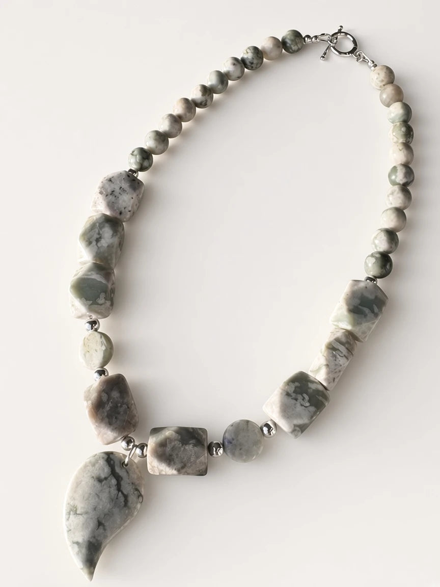 Hue La La Gems handcrafted statement necklace with sage, grey, and cream stone beads and a teardrop focal pendant.
