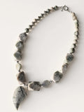 Hue La La Gems handcrafted statement necklace with sage, grey, and cream stone beads and a teardrop focal pendant.
