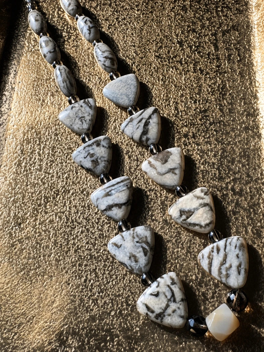Hue La La Gems artisan statement necklace featuring cream and charcoal jasper-style triangular and oval stone beads.