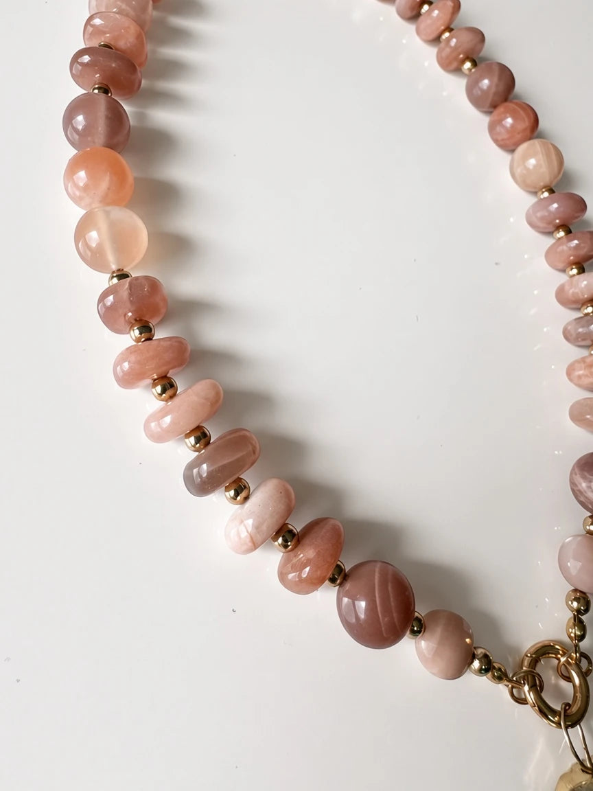 Hue La La Gems beaded statement necklace featuring polished peach and rose sunstone beads with gold-tone spacers.
