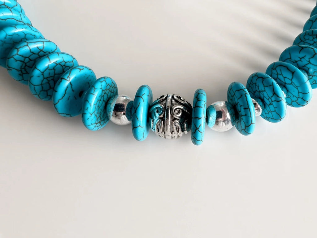 Hue La La Gems turquoise-style beaded necklace with bright blue disc beads, silver spacers, and engraved metal accents.