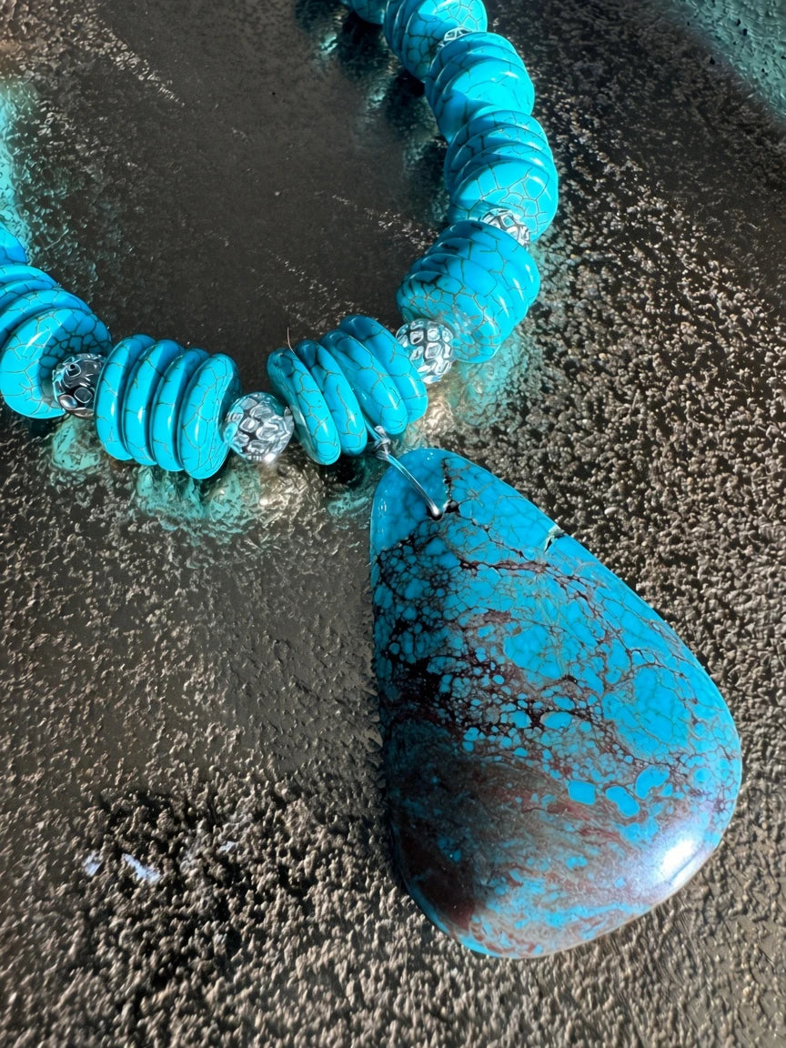 Hue La La Gems turquoise statement necklace with a large teardrop pendant, disc beads, and silver-tone accents.