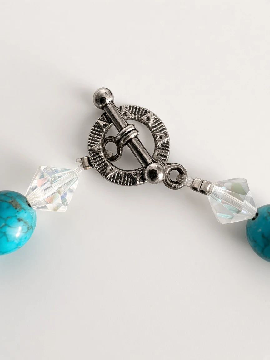 Hue La La Gems turquoise beaded necklace featuring a detailed engraved silver-tone toggle clasp and clear crystals.