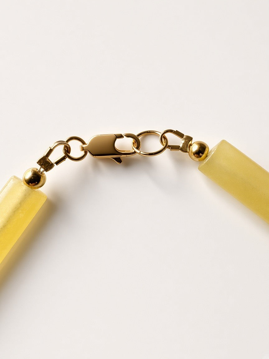 Hue La La Gems yellow matte cylinder bead necklace featuring polished gold-tone spacers and a secure lobster clasp.