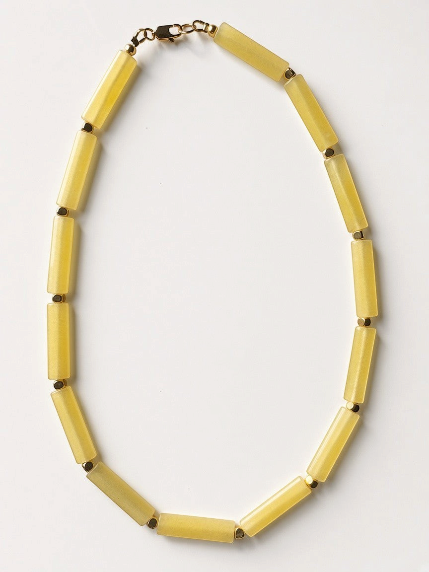 Hue La La Gems yellow matte cylinder bead necklace with gold-tone spacers and a lobster clasp on a white background.
