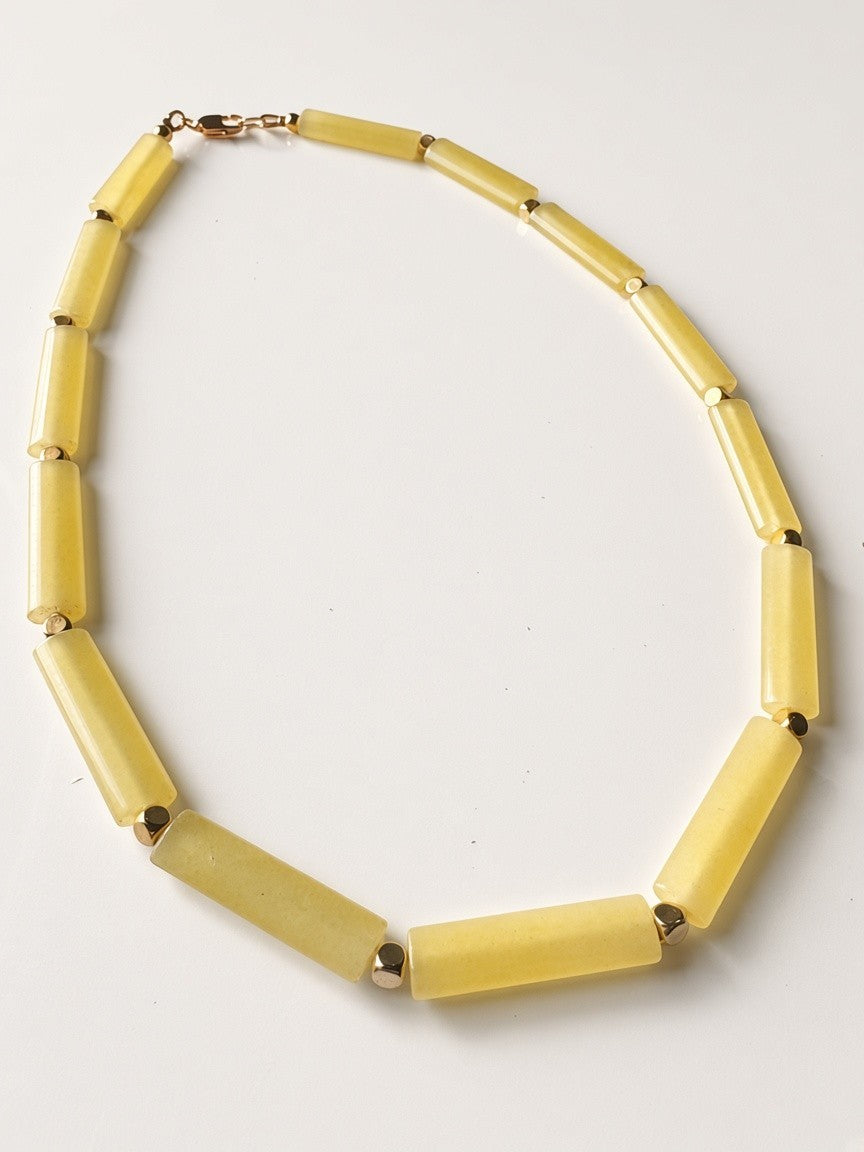 Hue La La Gems yellow cylinder bead necklace with gold-tone spacers and a lobster clasp on a white background.